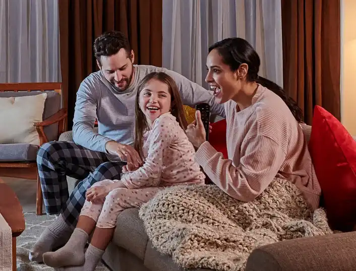 family on couch watching television